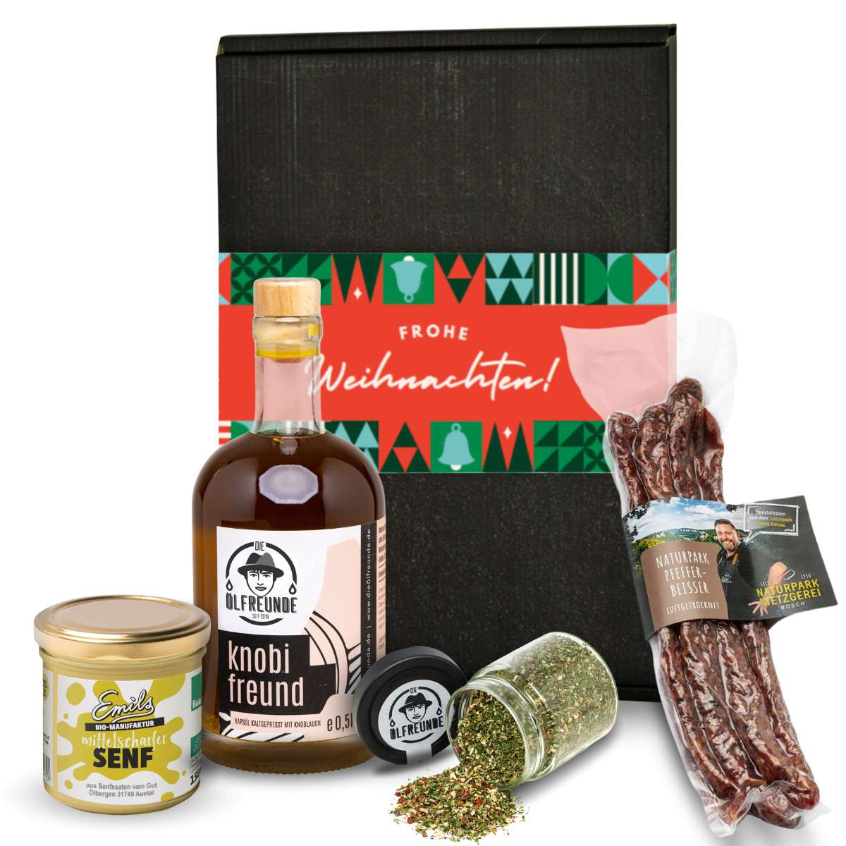Knoblauchöl und Gewürzglas der Marke Die Ölfreunde, Pfeffer-Beisser der Marke Naturpark Metzgerei Bosch und mittelscharfer Senf der Marke Emils Bio-Manufaktur, vor einer Weihnachts-Geschenkverpackung.