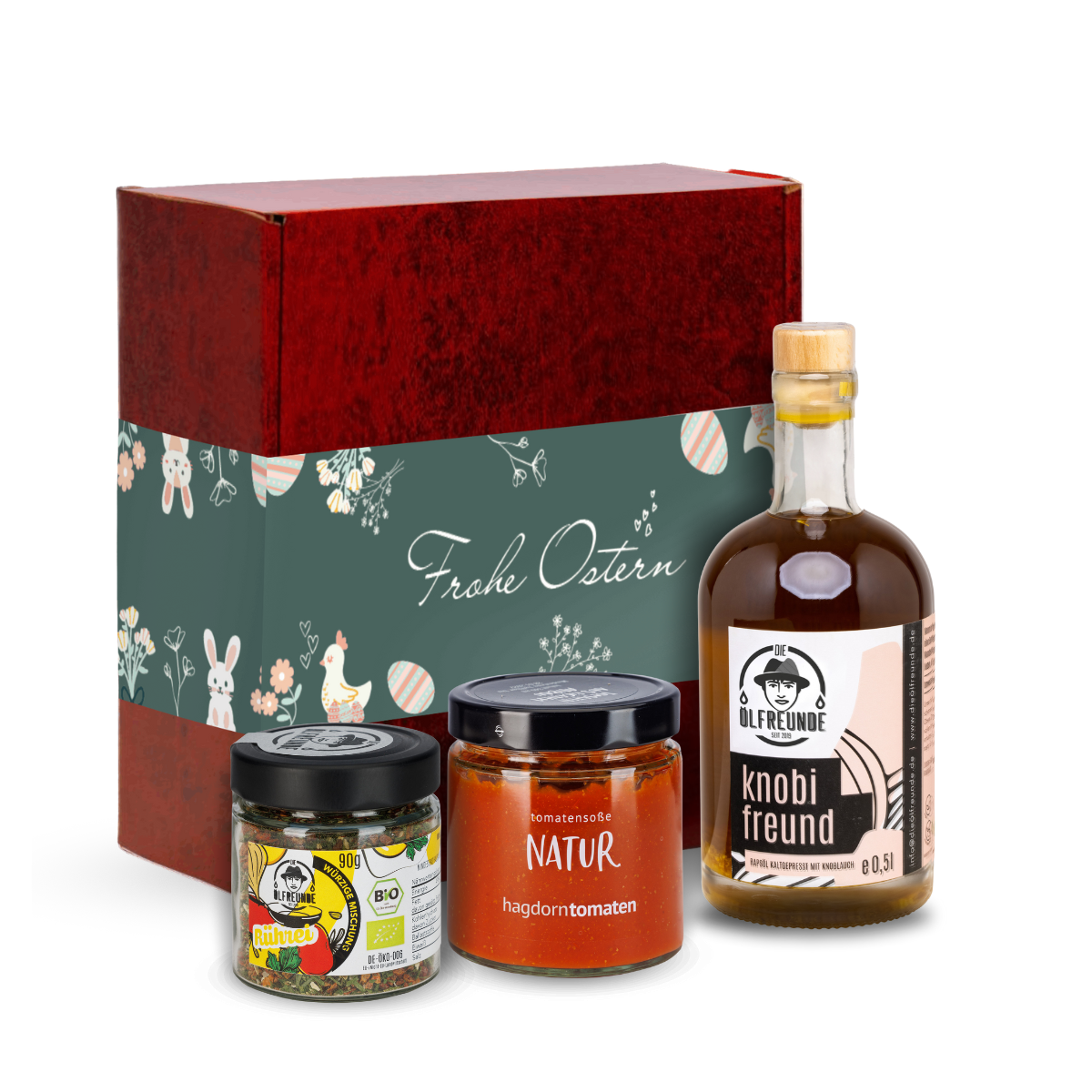 Knoblauchöl und Rühreigewürz der Marke Die Ölfreunde sowie Tomatensoße Natur der Marke Hagdorn Tomaten vor einer Oster-Geschenkverpackung.