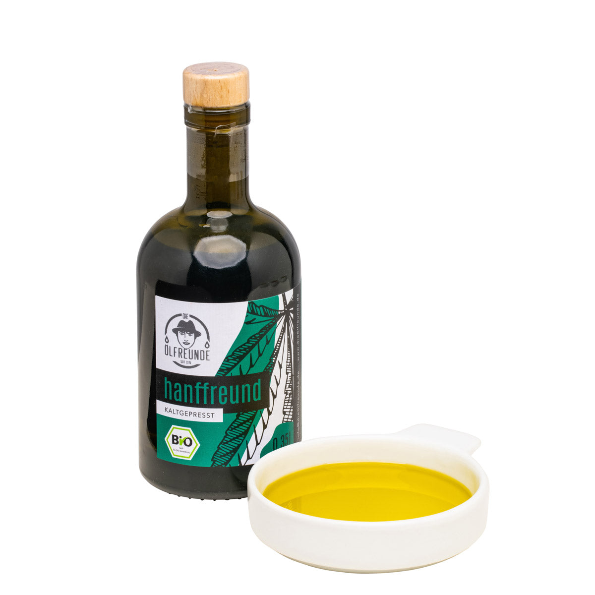 350-ml-Flasche Hanföl von Marke Die Ölfreunde, daneben Schale mit Hanföl.