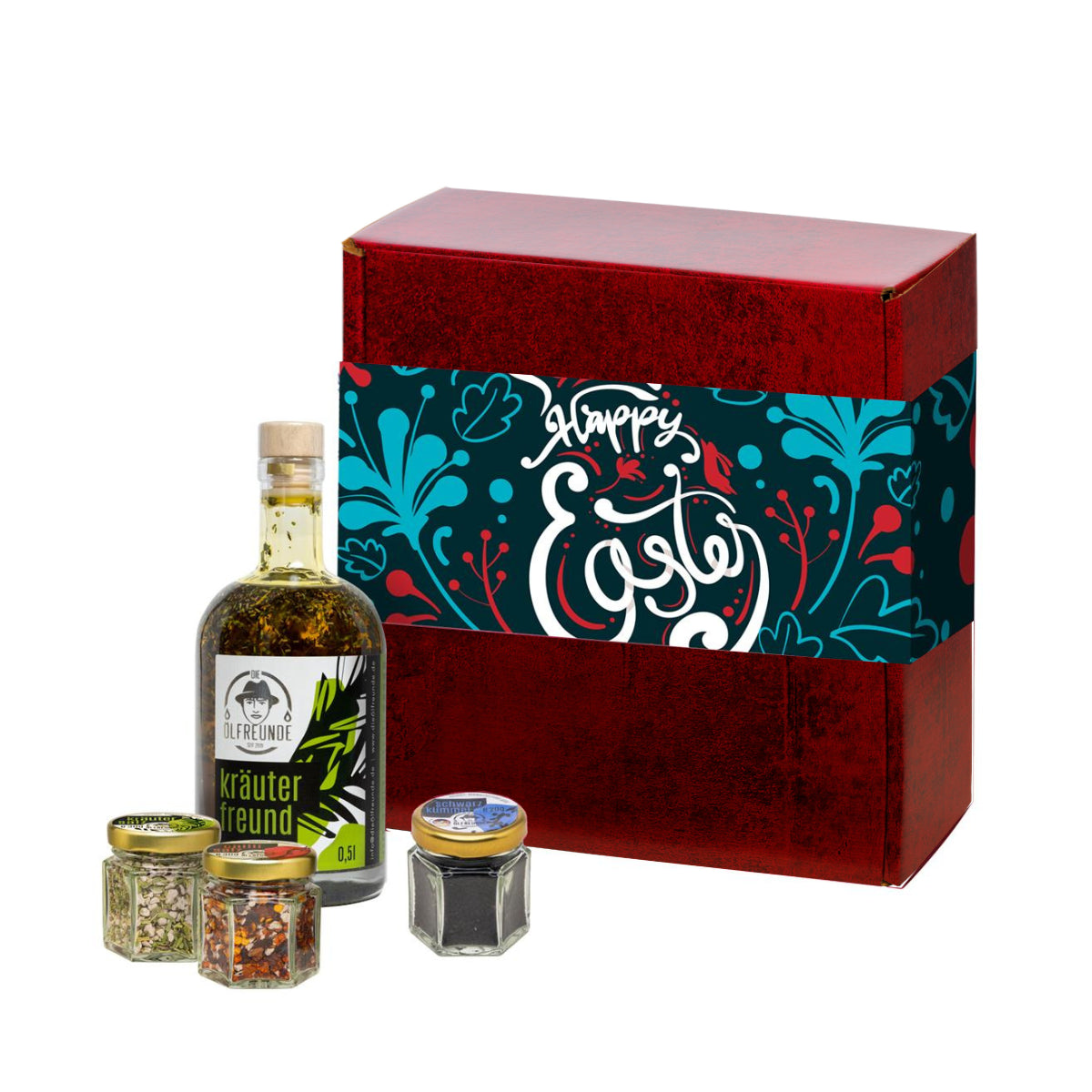 Eine Flasche Kräuteröl, ein Glas Kräutersalz, ein Glas Chillisalz und ein Glas Schwarzkümmel der Marke Die Ölfreunde, vor einer Oster-Geschenkverpackung.