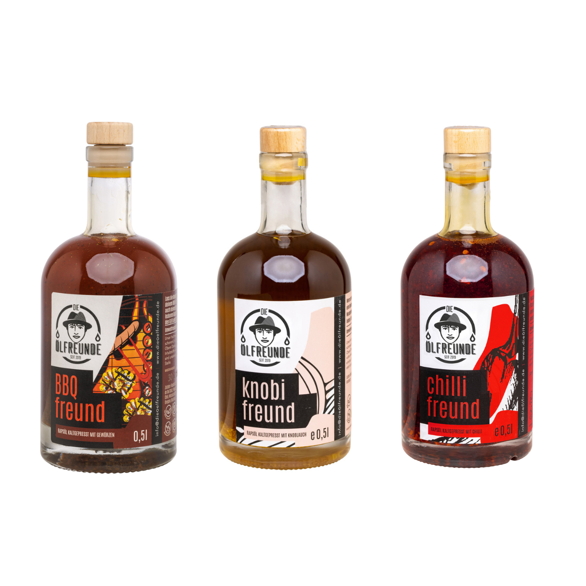 Drei Glasflaschen mit verschiedenen Ölen der Marke ‚Die Ölfreunde‘ – BBQ-Öl, Knoblauchöl und Chilli-Öl.